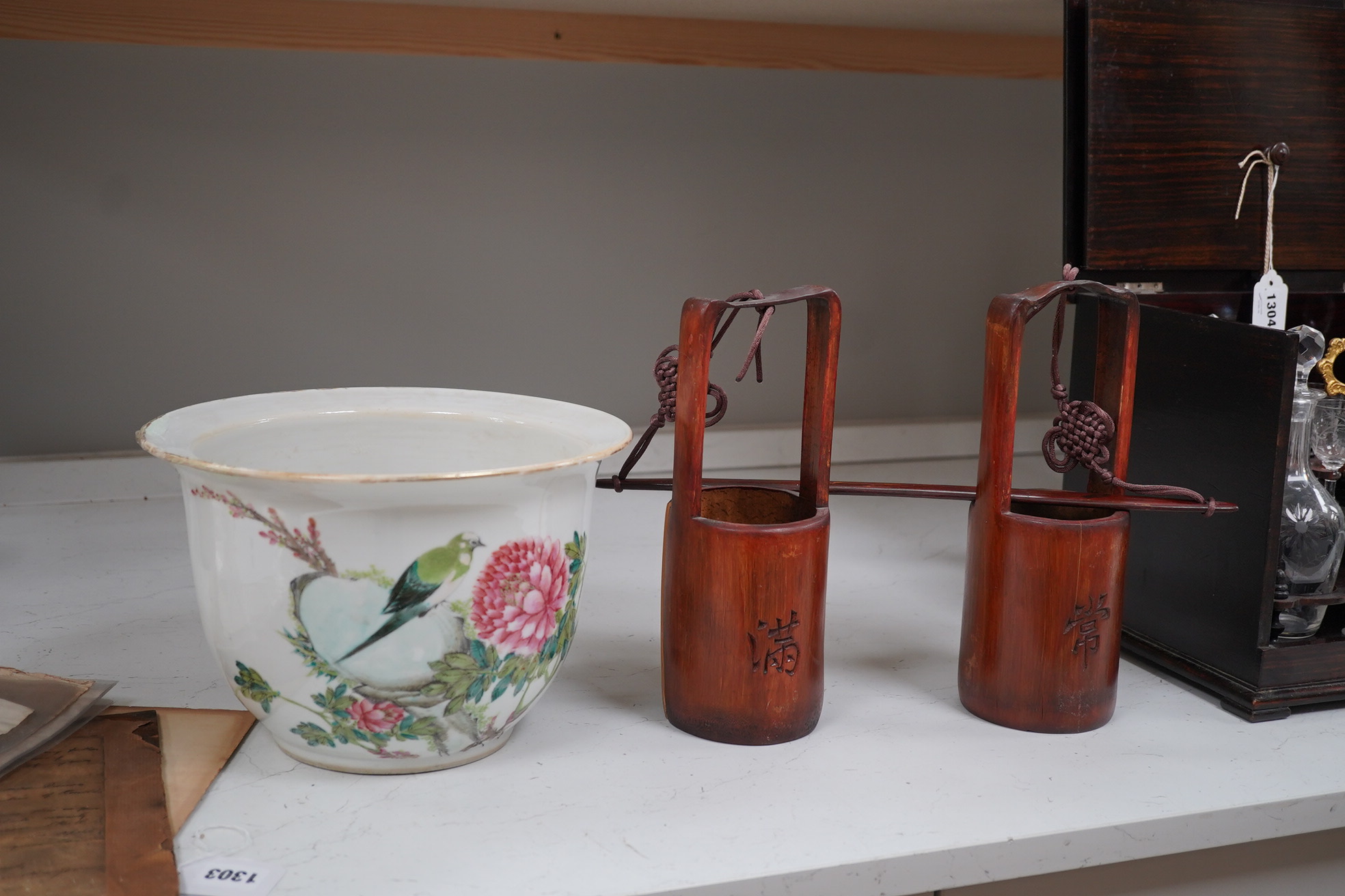 A Chinese famille rose jardiniere and bamboo oak rail, famille rose jardiniere 27cm diameter. Condition - jardiniere cracked from rim and restored, bamboo side cracked